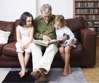Good Hearing is important for family life - Picture of man reading to grand children - Access Hearing Centre, Dun Laoghaire, Co. Dublin, Ireland